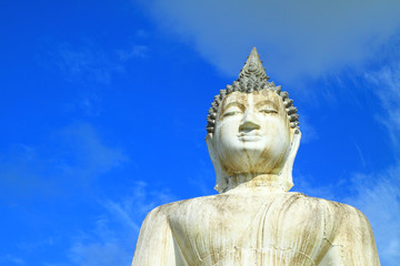 Fototapeta na wymiar Half buddha statue on blue sky
