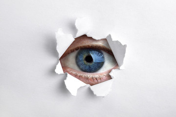 Looking through a hole in white paper - obrazy, fototapety, plakaty