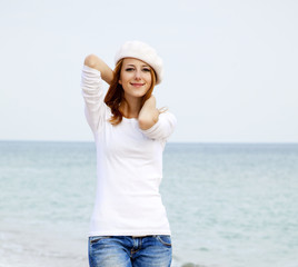 Young beautiful girl walking at the beach