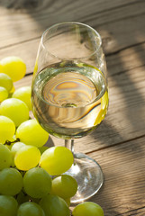 wine and grapes on wooden table