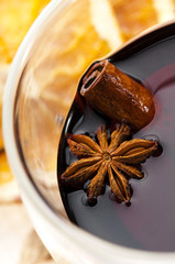 Mulled wine with slice of orange and spices.