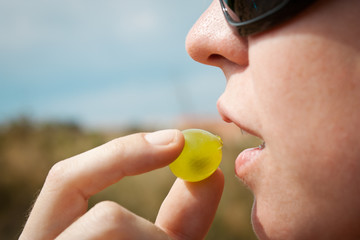 Woman eating a grape