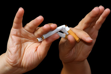 Hand breaking a cigarette. Stop smoking