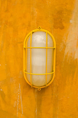 electric lamp on old yellow wall