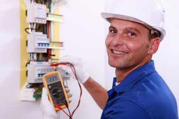 Electrician checking a fuse box