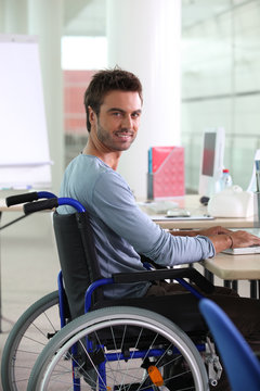 Man in wheelchair working at computer