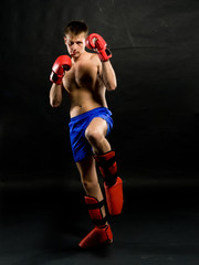 Portrait of young man with boxing  gloves