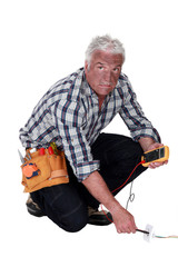 Electrician checking the voltage and getting a shock