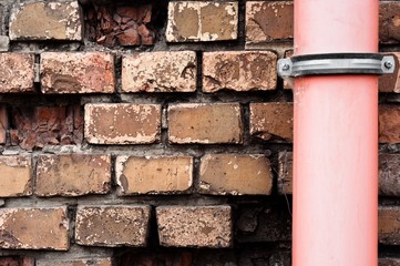 Drain pipe against brick wall