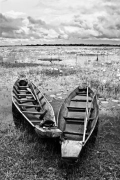 Abandoned native Thai style wood boat in black and white