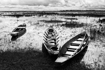 Abandoned native Thai style wood boat in black and white