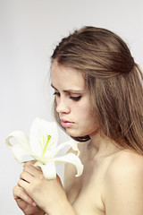 young and beautiful girl model with a white lily