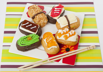 Fake sushi donut in flower plate on green mat