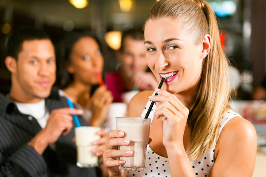 Friends Drinking Milkshakes In A Bar