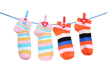 Bright striped socks on line  isolated on white