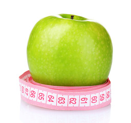 green apple and measuring tape isolated on white