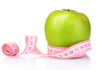 green apple and measuring tape isolated on white