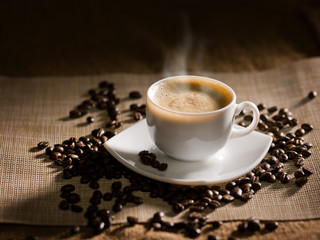 warm cup of coffee on brown background