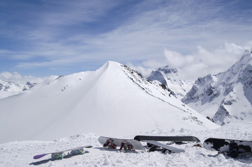Fototapeta na wymiar Snowboards against the top of mountain
