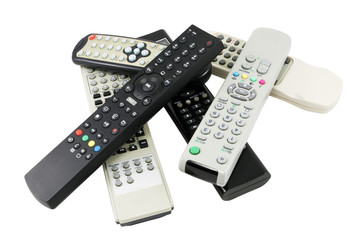 A pile of remote control devices isolated on white