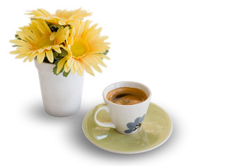 Ceramic cup of coffee and yellow flower