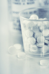 Medicine bottles and pills close up