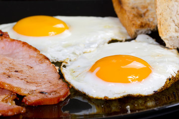 Irish breakfast with two eggs, bacon and toast