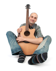 man sits with a guitar