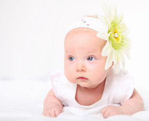 Portrait of a baby girl with a flower on her head