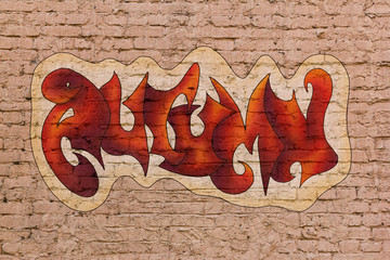 The word Autumn in street graffiti style placed upon brick wall