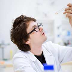 young, male researcher/chemistry student carrying out scientific