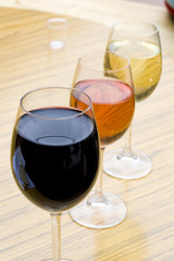 Three glasses of wine in red, pink and white color