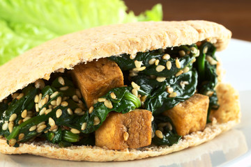 Wholewheat pita bread filled with tofu, spinach, sesame