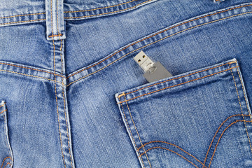 Flash USB drive memory coming out of jeans pocket