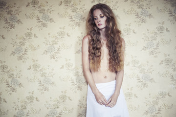 Naklejka premium Photo of young beautiful woman with red curly hair