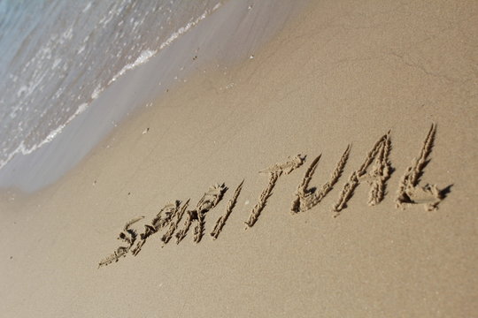 The word SPIRITUAL written in the sand