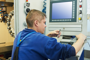 worker operating CNC machine center
