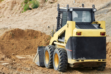 skid steer loader at earth moving works