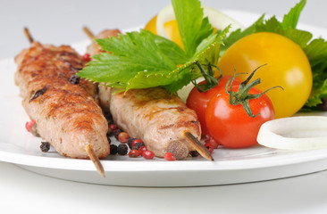 kebabs served with tomatoes and parsley