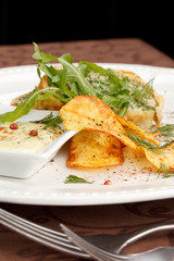 fish pie with sauce and potato chips