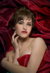 woman laying on red silk