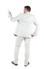 Businessman pointing at wall. rear view.