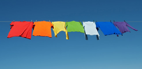 Rainbow laundry, bright shirts on a clothesline