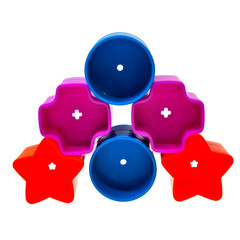 Colorful baby multishaped toys stacked over white background.