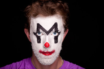 A man with clown makeup on his face