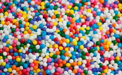 Fototapeta na wymiar Colorful sprinkles of sweet decoration topping for background