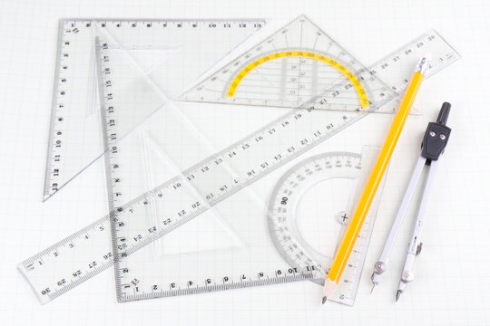 Set of mathematics school tools on squared paper