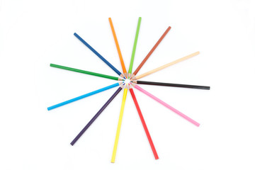 Set of colored pencils in the shape of a star. On a white backgr