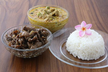 Thai food beef curry and sweet pork with rice in wood background