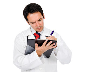 Medical doctor with stethoscope writing notes at notebook . Isol